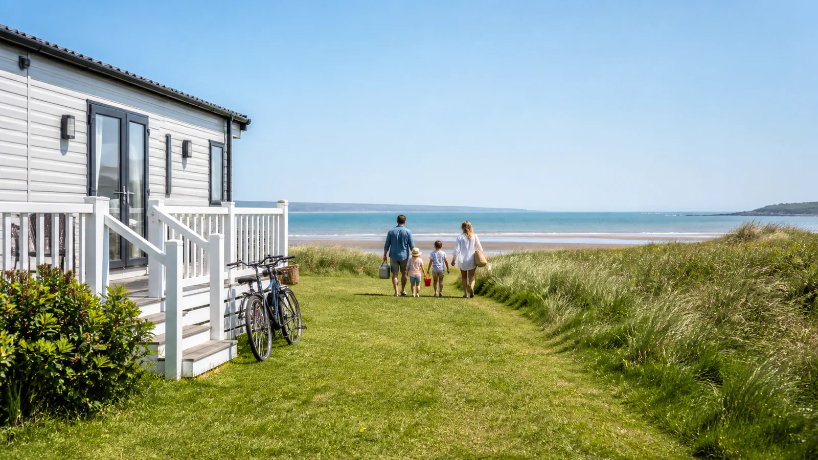 Family walking from a coastal holiday caravan toward the beach with bicycles nearby
